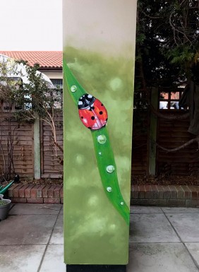 Ladybug wall art in garden