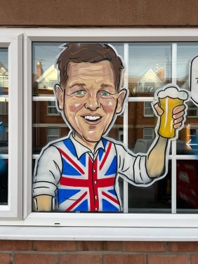 Landlord caricature window art at The British Flag